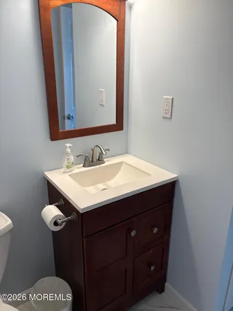 a bathroom with a sink vanity and a mirror