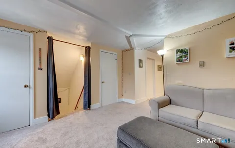 a living room with furniture and a glass door
