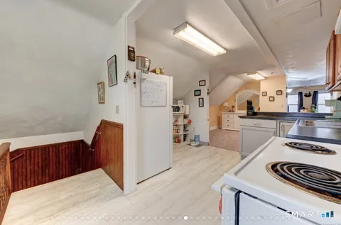 a view of kitchen with furniture and wooden floor