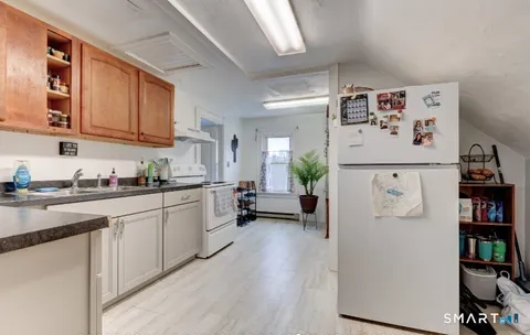 a kitchen with stainless steel appliances granite countertop a refrigerator sink and cabinets