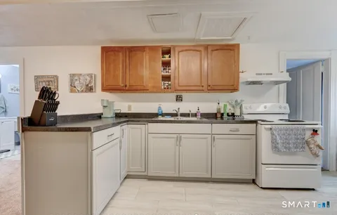 a kitchen with stainless steel appliances granite countertop a refrigerator sink and cabinets