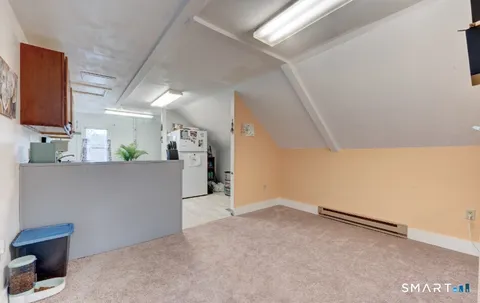 a view of a room with wooden floor and cabinet