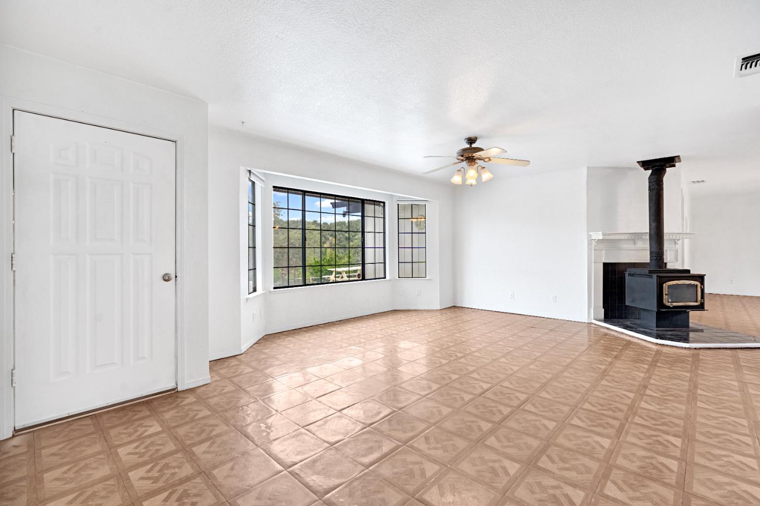 29668 Seminole Road Tollhouse, CA 93667 - Photo 25 of 28 a view of an empty room with a ceiling fan and window