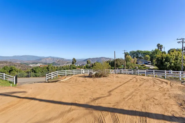 a view of a swimming pool with a yard and mountain view