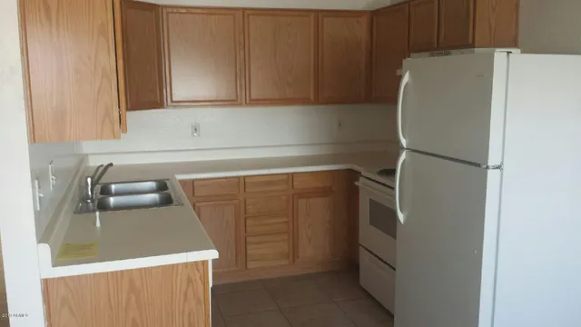 a close view of a sink and a refrigerator in a kitchen