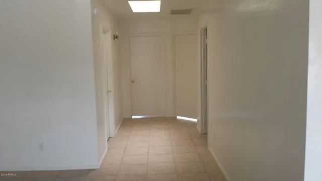 a view of an empty room with a bathroom