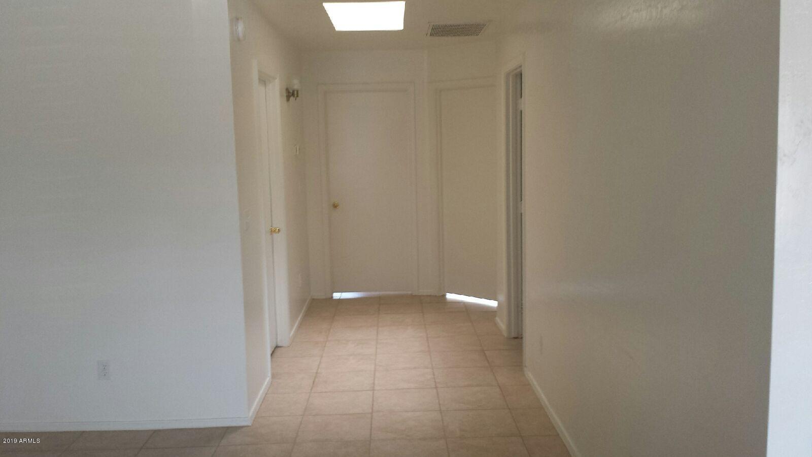1497 East 26th Lane, Unit 2 Apache Junction, AZ 85119 - Photo 2 of 6 a view of an empty room with a bathroom