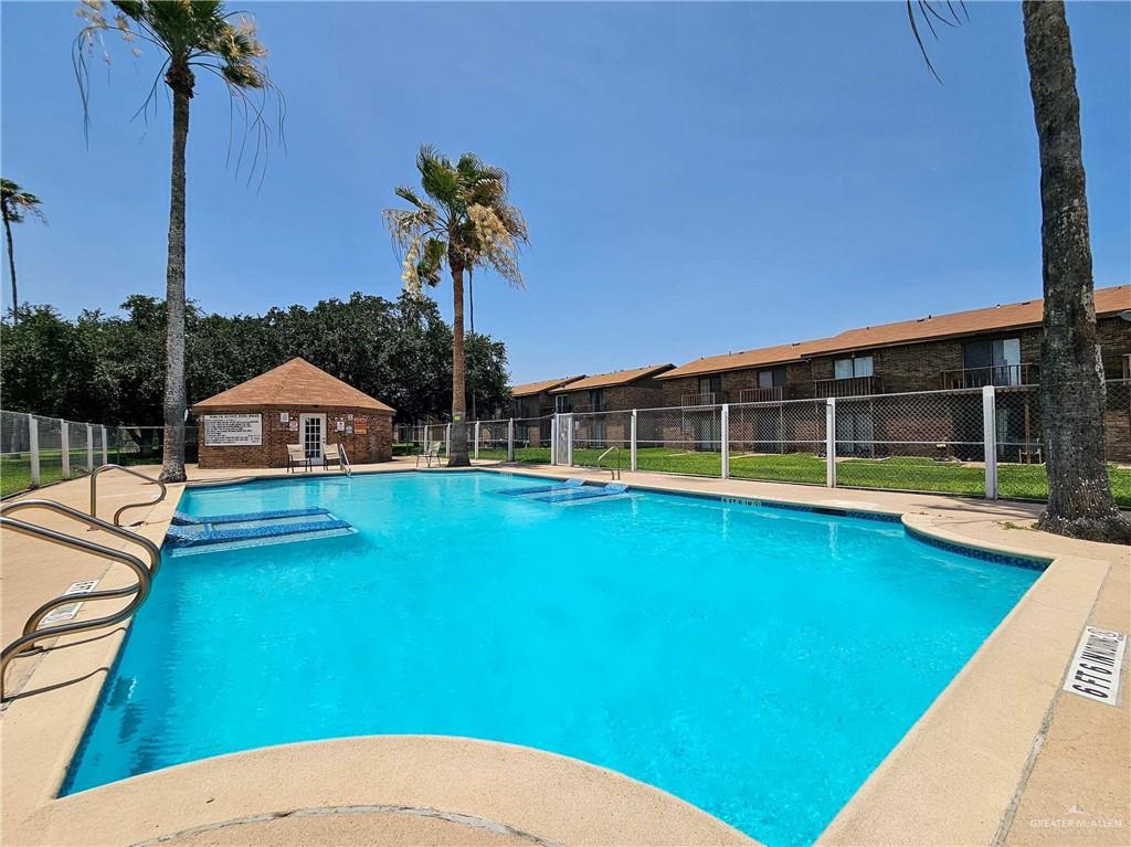 2201 South Jackson Road, Unit 2I Pharr, TX 78577 - Photo 20 of 23 Outdoor swimming pool with integrated spa, surrounded by concrete decking and a chain-link fence