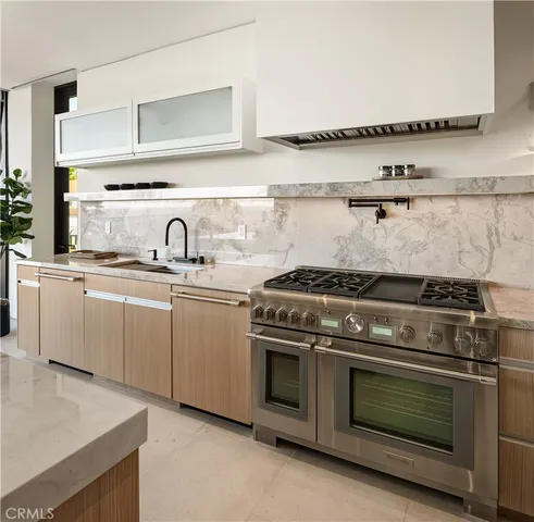 a kitchen with a stove and a sink