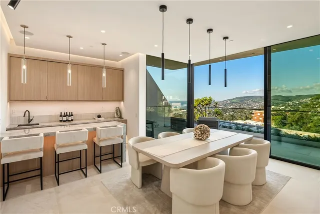 a dining room with a table chairs and a floor to ceiling window