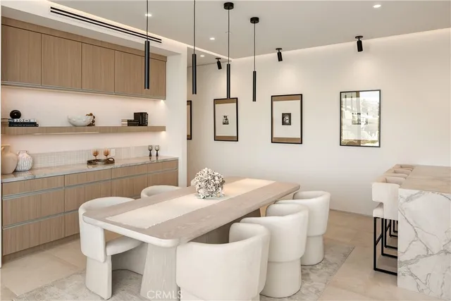 a kitchen with a white cabinets and chairs