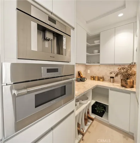 a kitchen with a stove and white cabinets