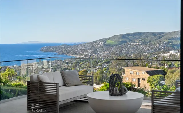 a view of a balcony with two chairs and a couch