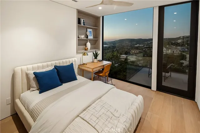 a bedroom with a large bed and a window