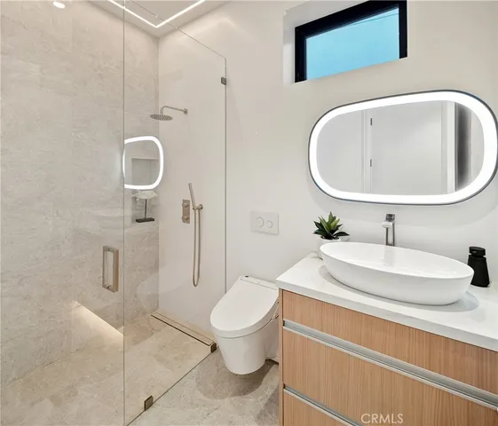 a bathroom with a toilet sink and shower