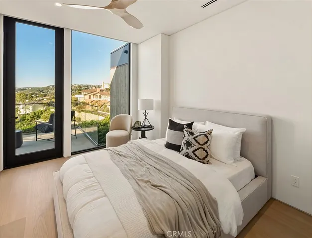 a bedroom with a large bed and a large window