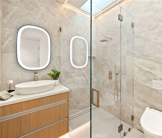 a bathroom with a double vanity sink mirror and shower