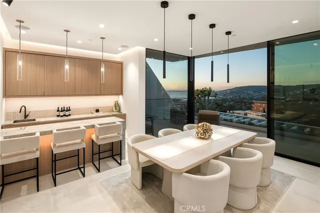 a kitchen with a table chairs stove and kitchen view