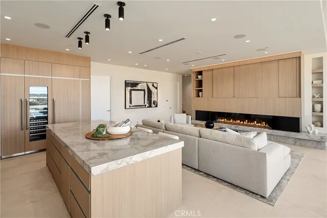 a living room with furniture and kitchen view
