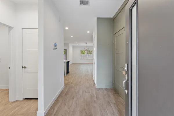 a view of a hallway with wooden floor