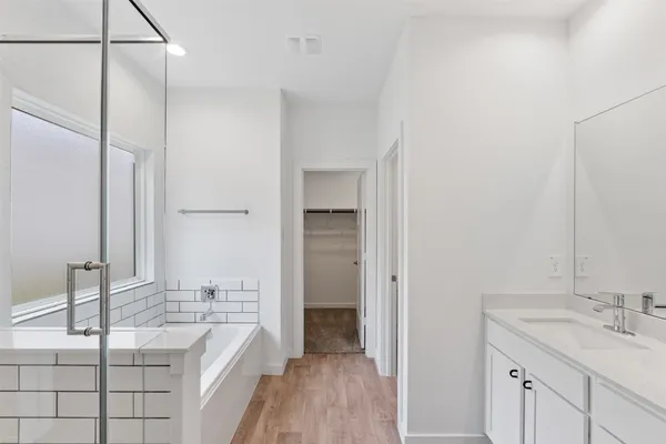 a bathroom with a granite countertop sink a mirror and shower