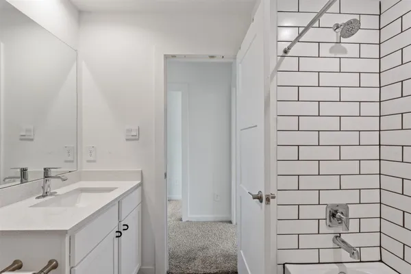 a bathroom with a sink and shower