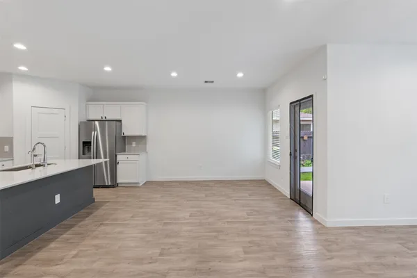 a view of kitchen with refrigerator and window