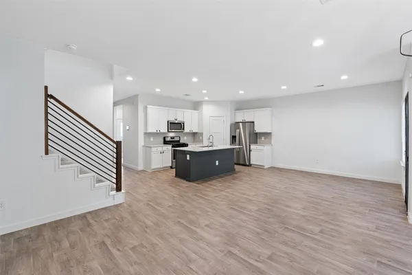 a kitchen with stainless steel appliances a refrigerator and a microwave