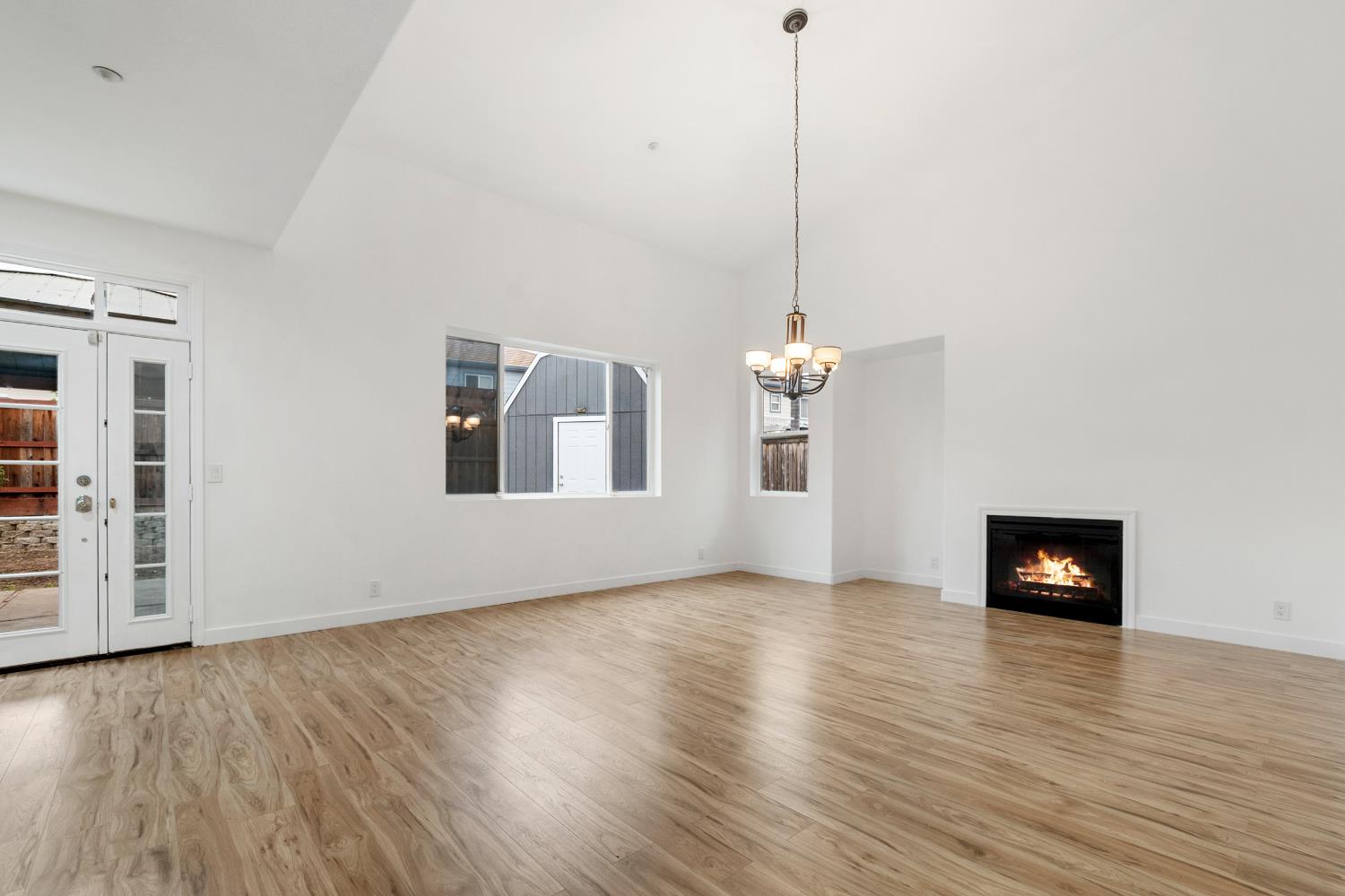 624 Snapdragon Street Winters, CA 95694 - Photo 11 of 65 a view of a room with wooden floor a fireplace and a window