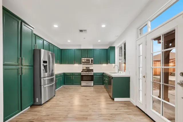 a kitchen with a refrigerator and cabinets