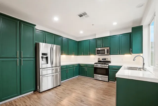 a kitchen with stainless steel appliances granite countertop a stove and a sink
