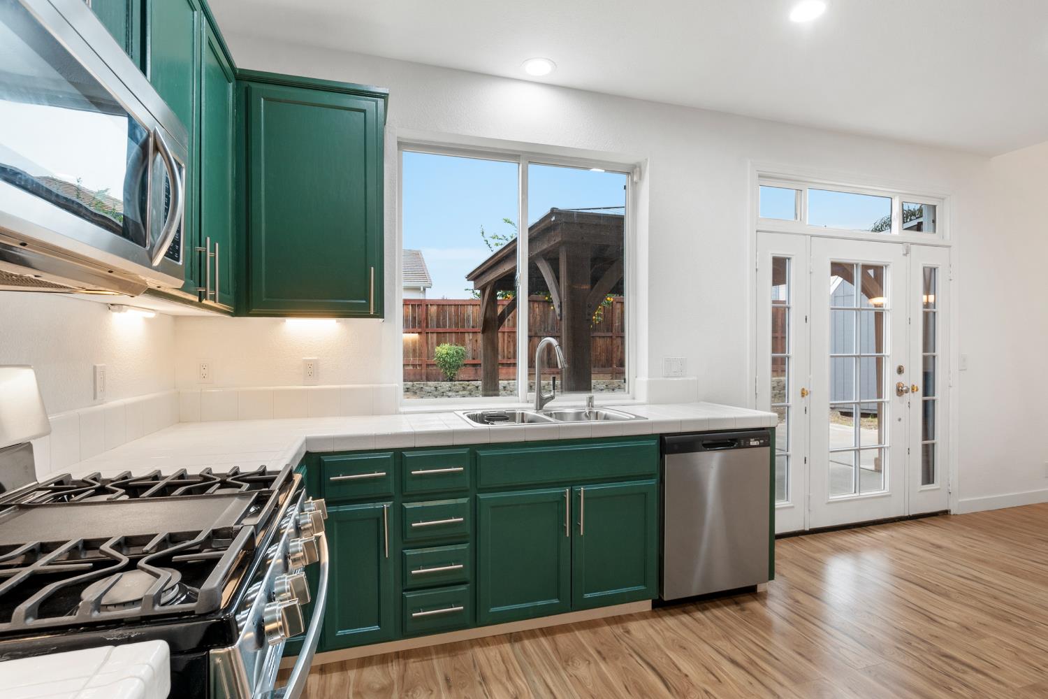 624 Snapdragon Street Winters, CA 95694 - Photo 20 of 65 a kitchen with stainless steel appliances granite countertop a sink and wooden cabinets