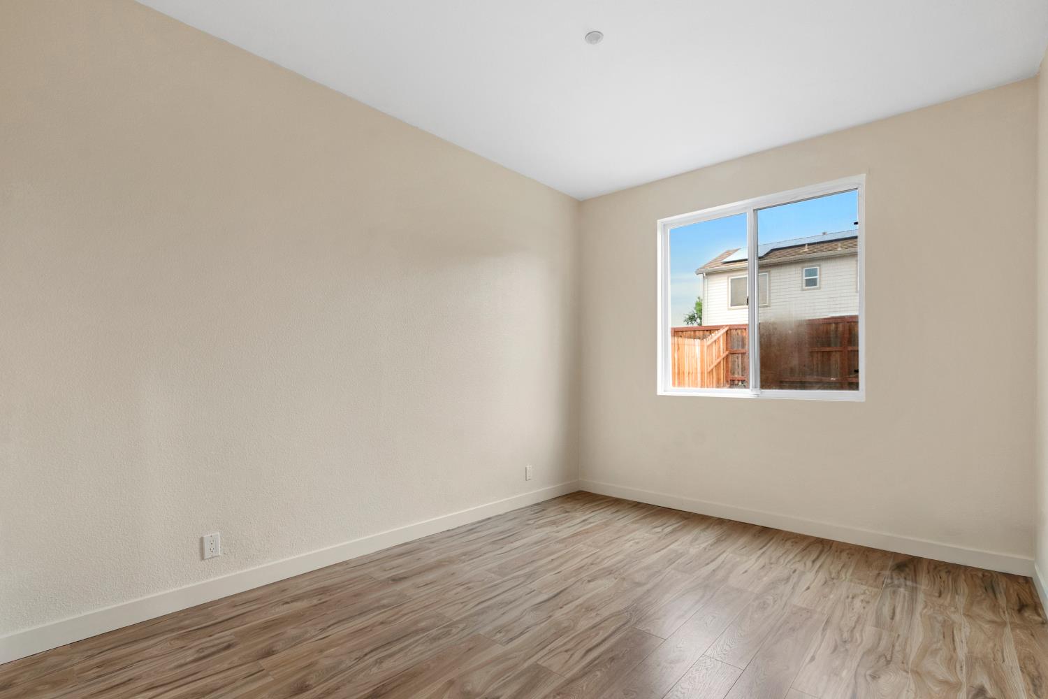 624 Snapdragon Street Winters, CA 95694 - Photo 24 of 65 an empty room with wooden floor and windows