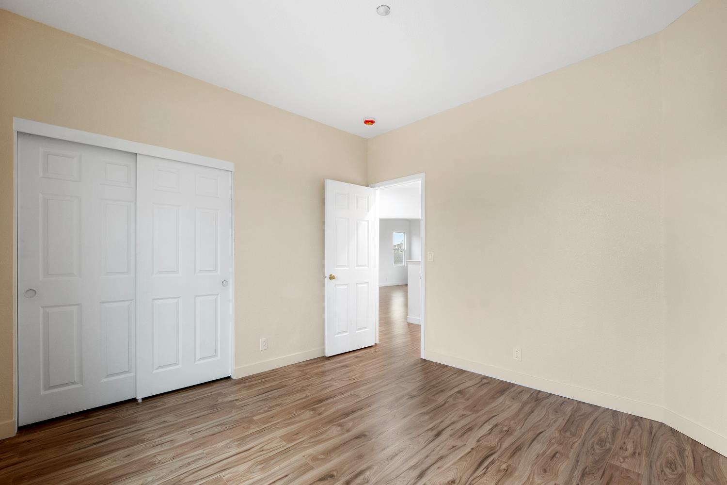 624 Snapdragon Street Winters, CA 95694 - Photo 30 of 65 a view of an empty room with wooden floor