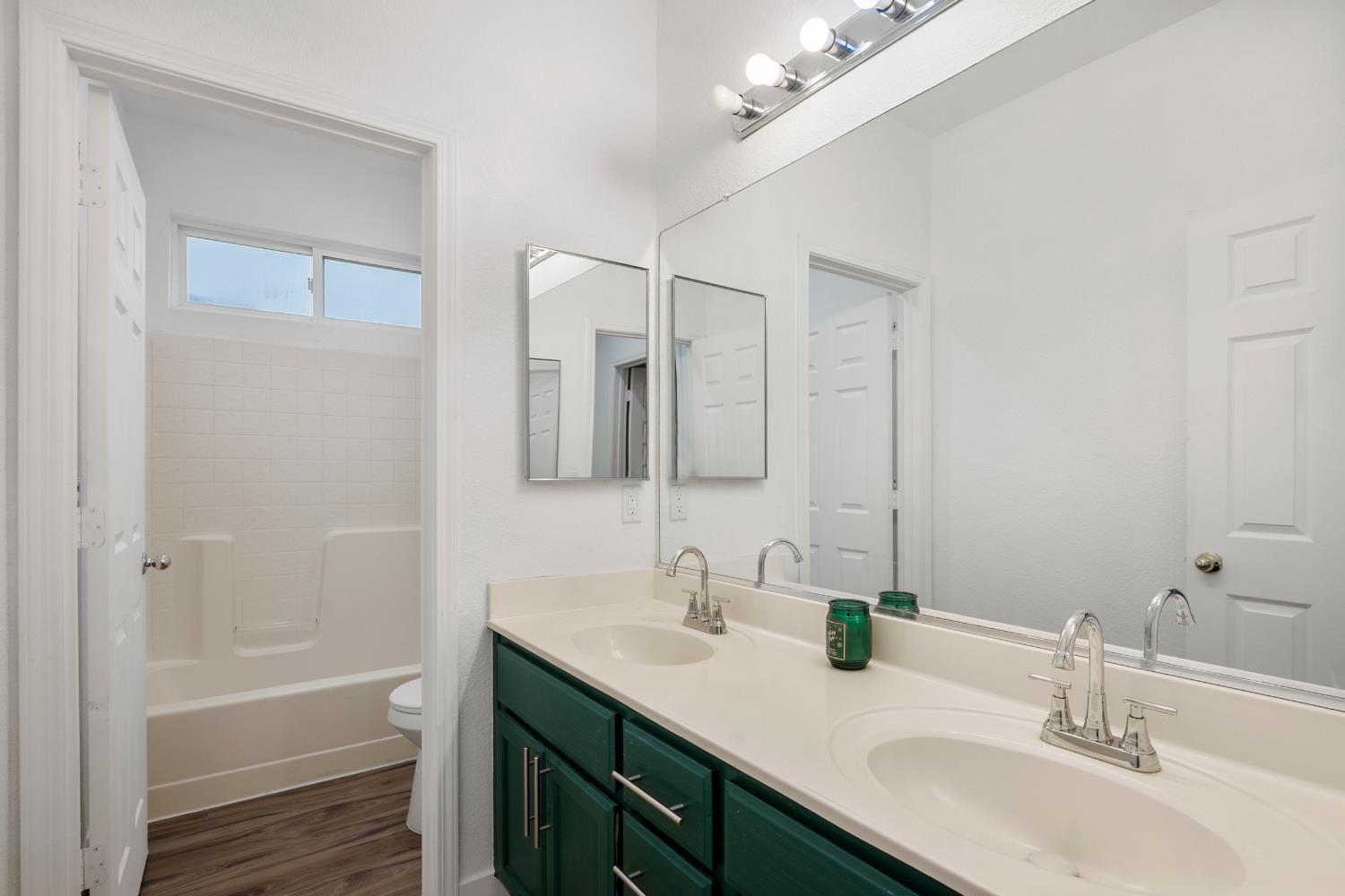 624 Snapdragon Street Winters, CA 95694 - Photo 33 of 65 a bathroom with a tub sink double vanity and mirror