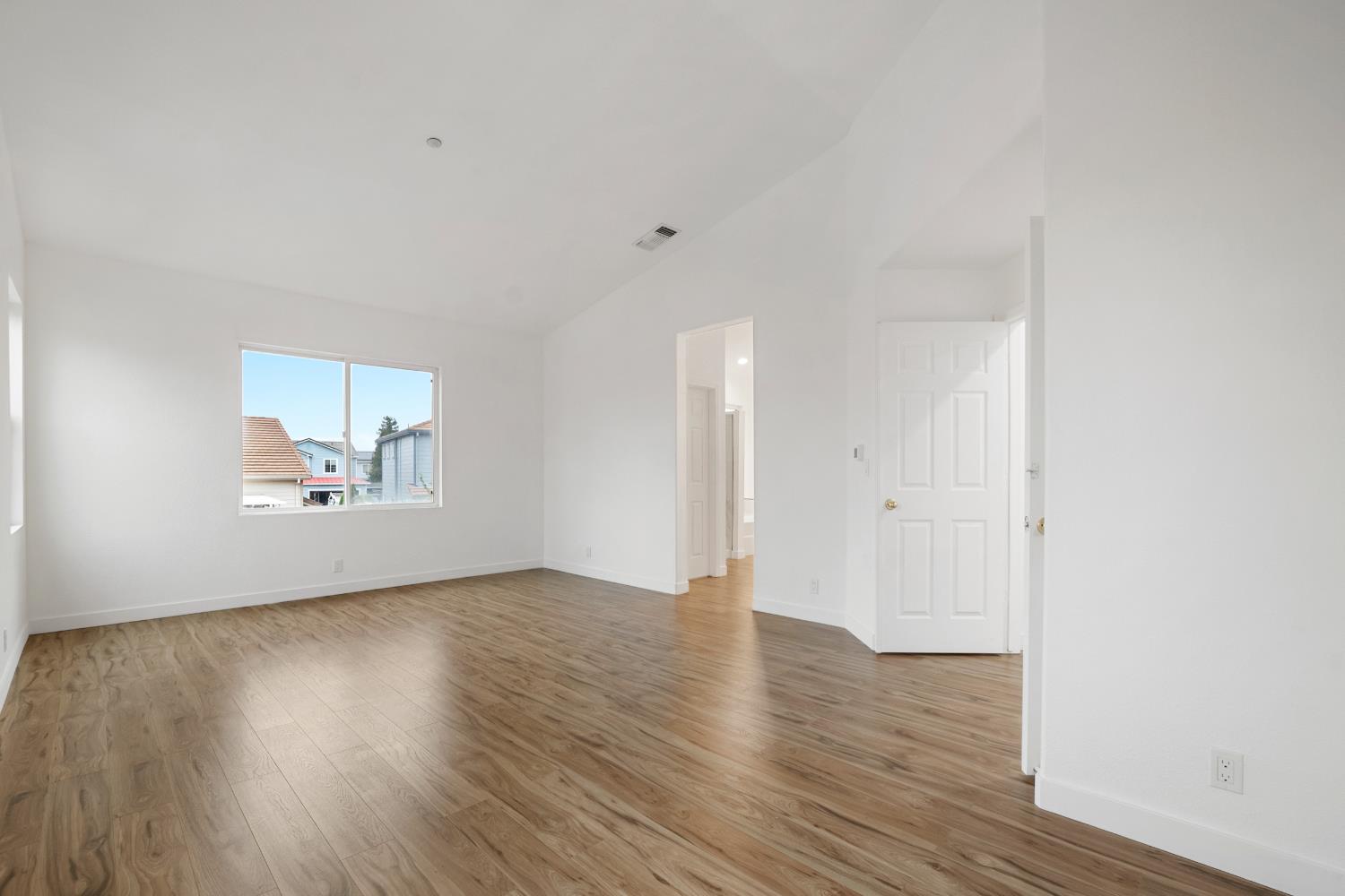 624 Snapdragon Street Winters, CA 95694 - Photo 36 of 65 a view of an empty room with wooden floor and a window