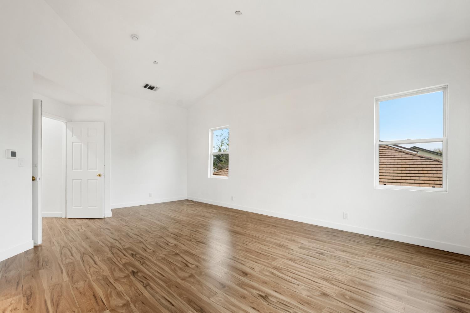 624 Snapdragon Street Winters, CA 95694 - Photo 38 of 65 an empty room with wooden floor and windows