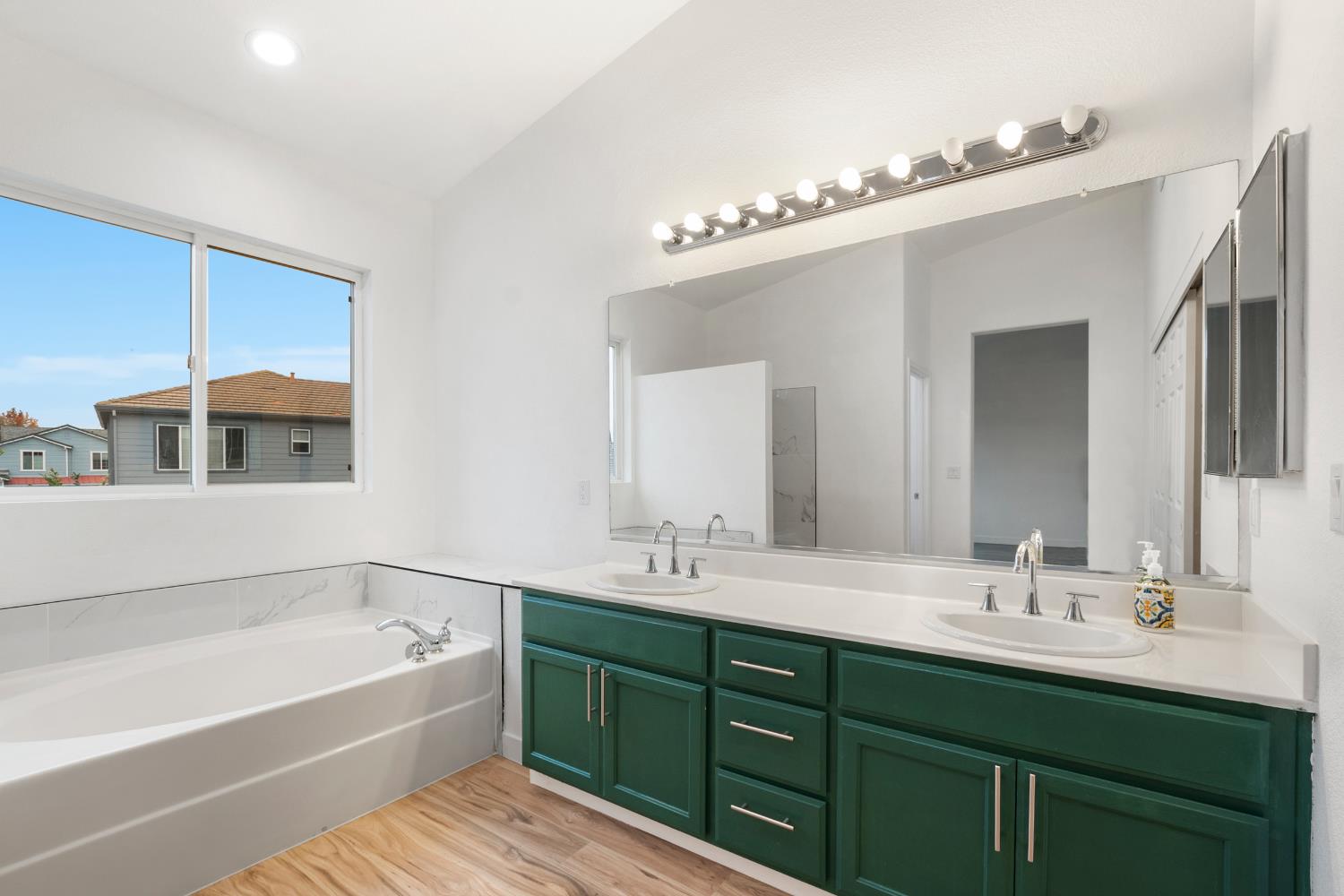 624 Snapdragon Street Winters, CA 95694 - Photo 40 of 65 a bathroom with a tub double sink double vanity and mirror