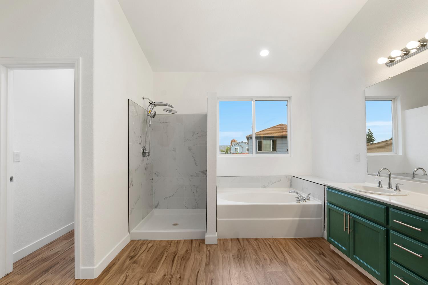 624 Snapdragon Street Winters, CA 95694 - Photo 41 of 65 a bathroom with a tub shower sink and mirror
