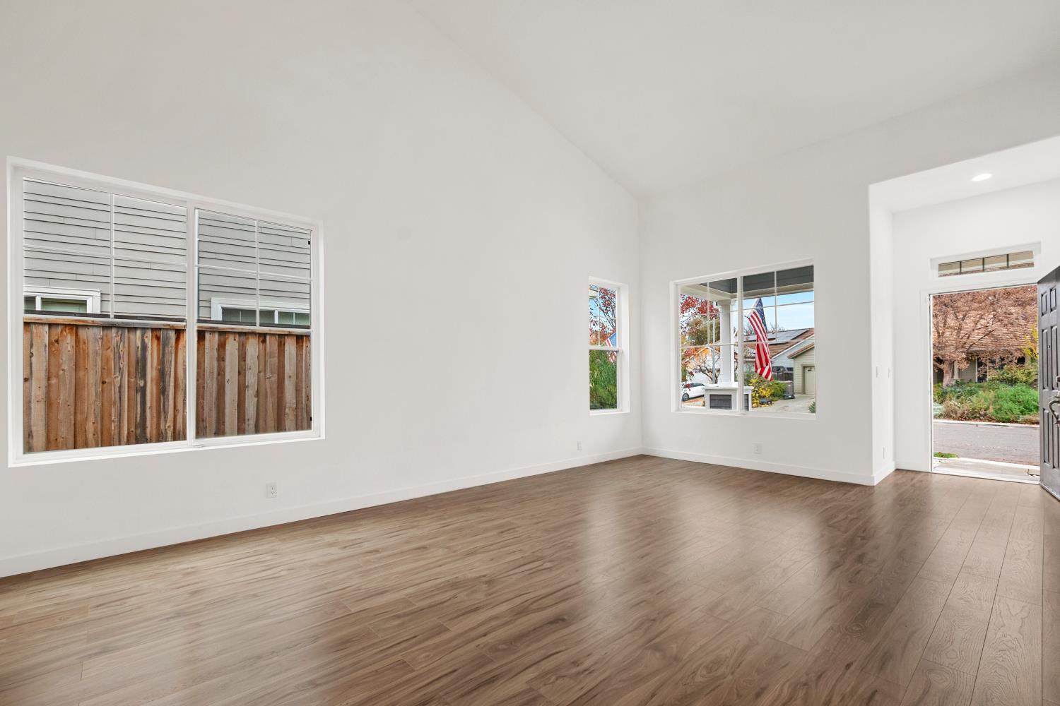 624 Snapdragon Street Winters, CA 95694 - Photo 6 of 65 a view of an empty room with wooden floor and a window