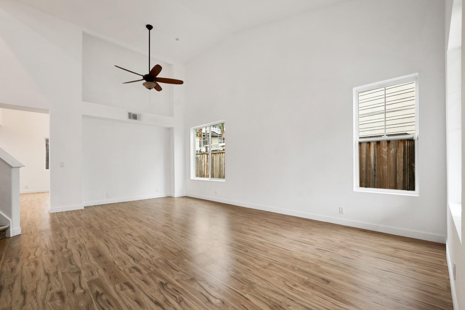 624 Snapdragon Street Winters, CA 95694 - Photo 8 of 65 a view of empty room with wooden floor and fan