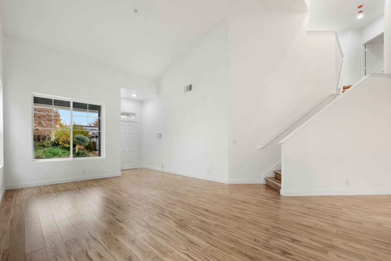 624 Snapdragon Street Winters, CA 95694 - Photo 10 of 65 a view of an empty room with wooden floor and a window