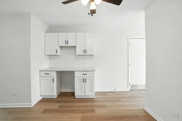 a view of kitchen with granite countertop cabinets and wooden floor