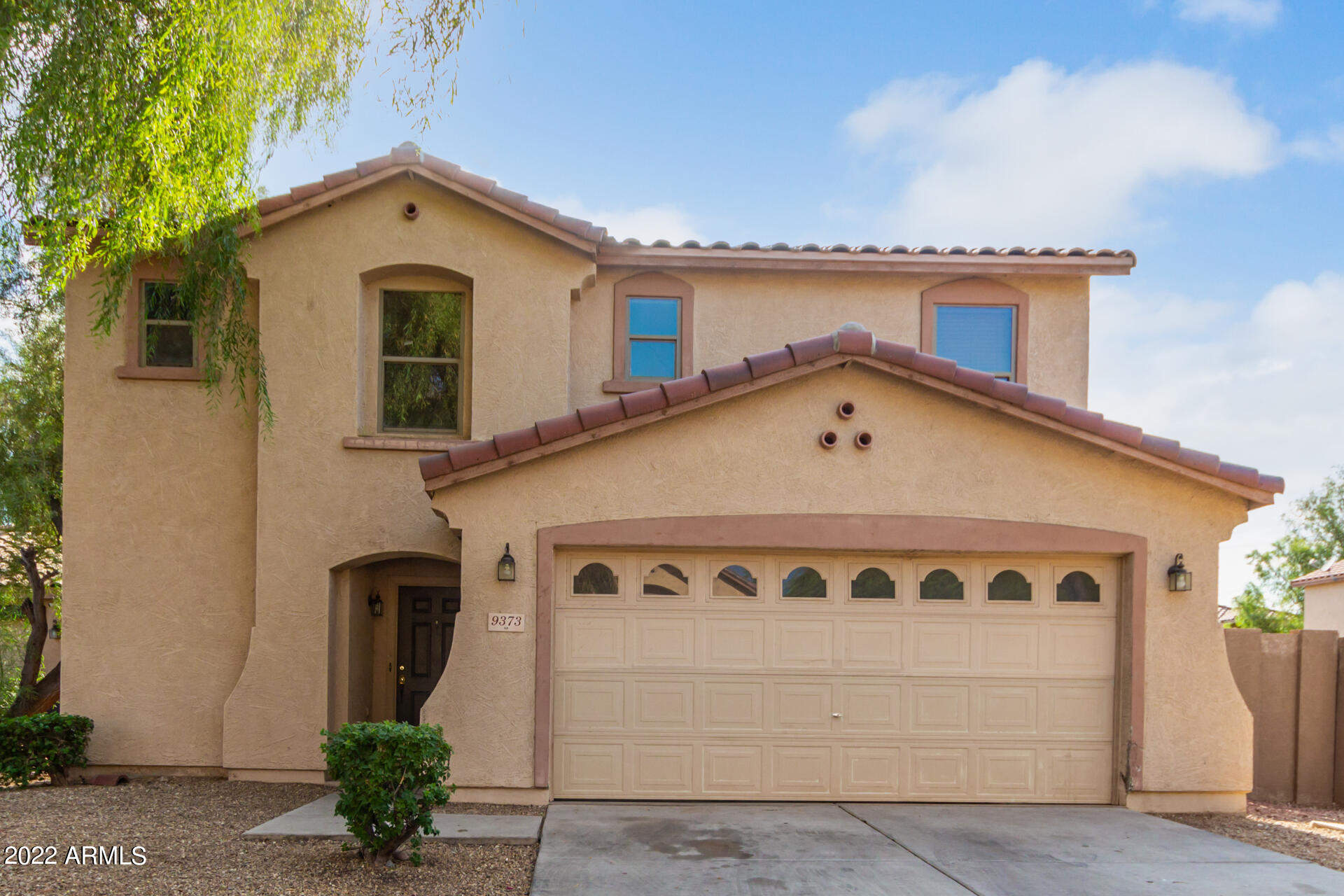 9373 West Eaton Road Phoenix, AZ 85037 - Photo 1 of 19 a front view of a house with a yard and garage