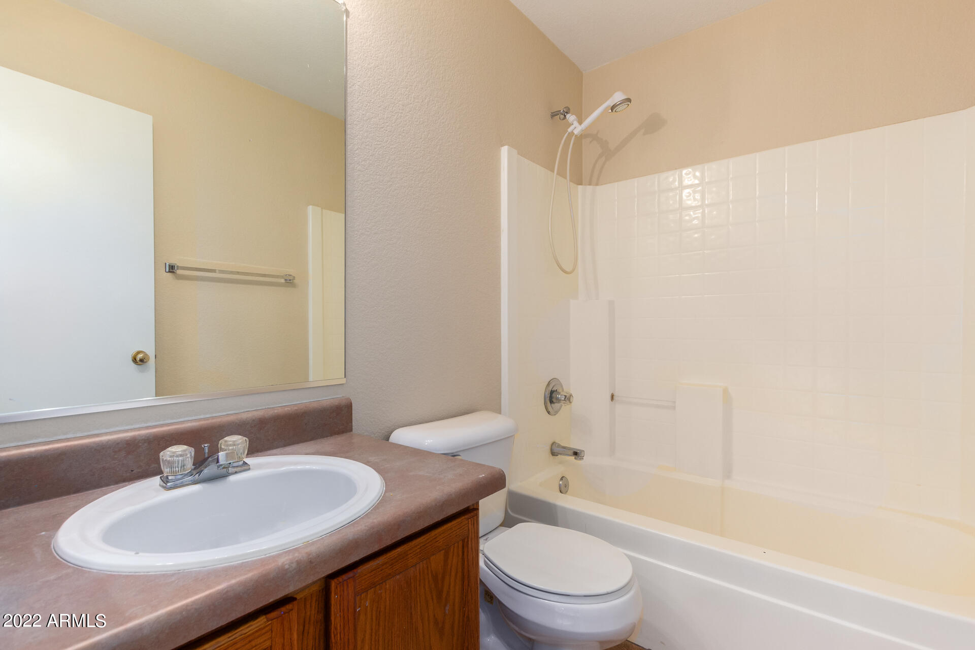 9373 West Eaton Road Phoenix, AZ 85037 - Photo 14 of 19 a bathroom with a sink a toilet and shower