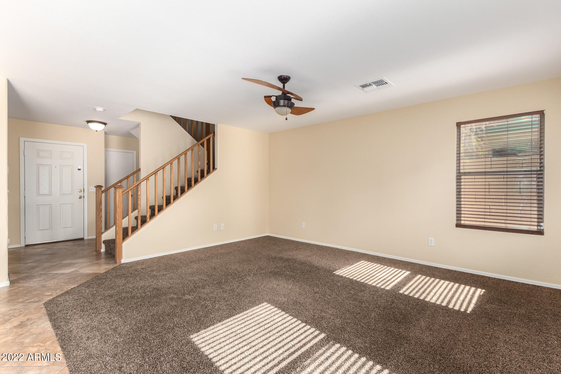 9373 West Eaton Road Phoenix, AZ 85037 - Photo 2 of 19 a view of an empty room with staircase