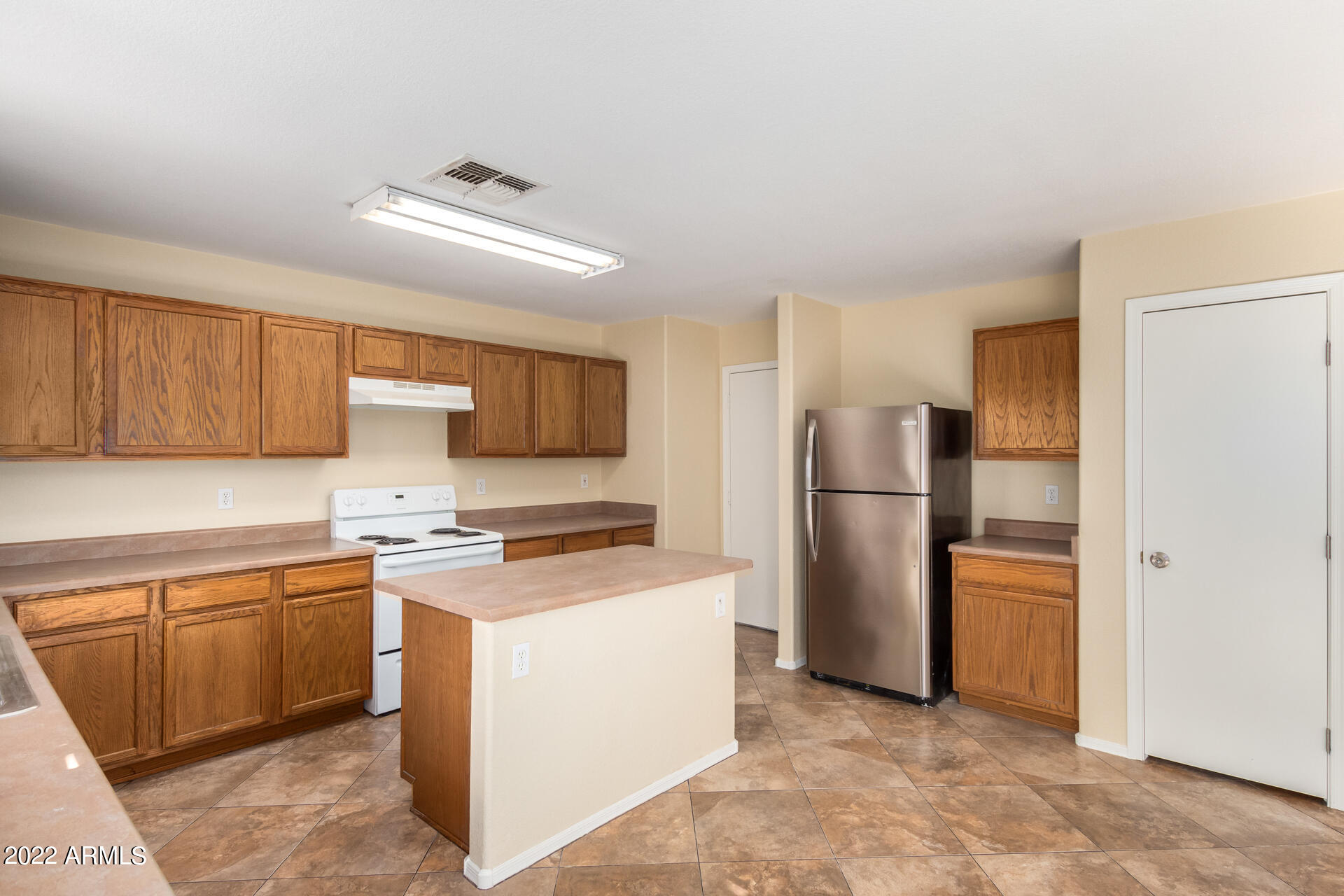 9373 West Eaton Road Phoenix, AZ 85037 - Photo 4 of 19 a kitchen with stainless steel appliances a refrigerator a stove a sink and a refrigerator