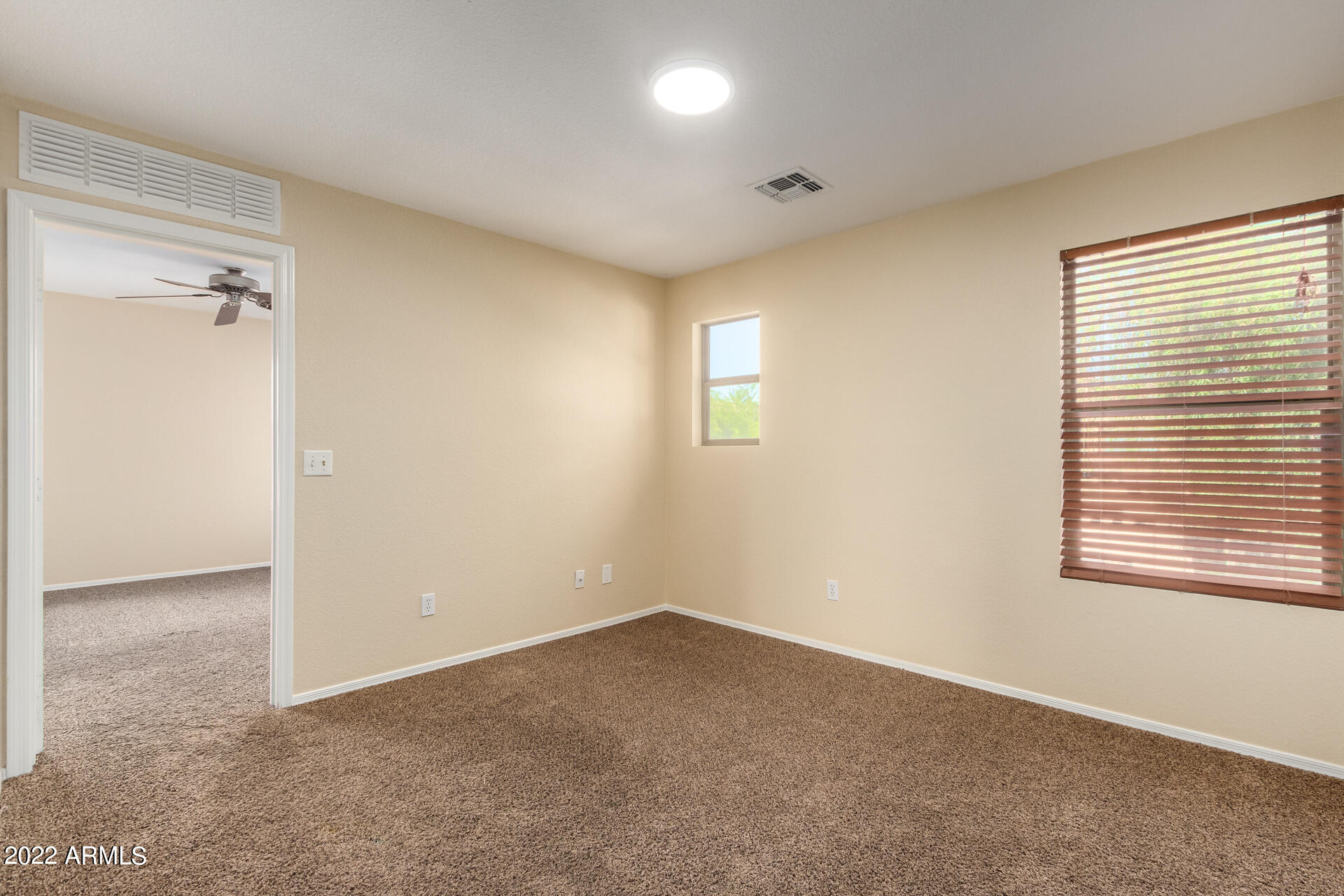 9373 West Eaton Road Phoenix, AZ 85037 - Photo 6 of 19 a view of an empty room with a window
