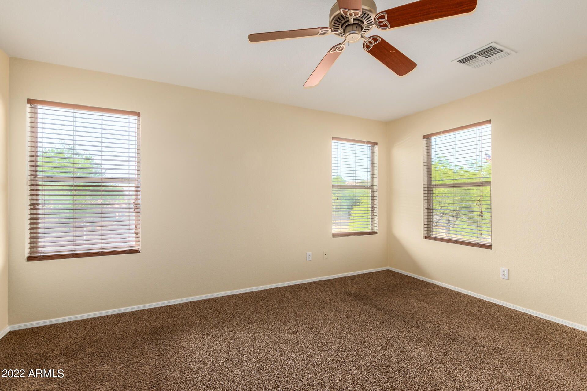 9373 West Eaton Road Phoenix, AZ 85037 - Photo 8 of 19 a view of an empty room with chandelier fan and a window