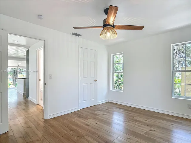 wooden floor in an empty room with a window